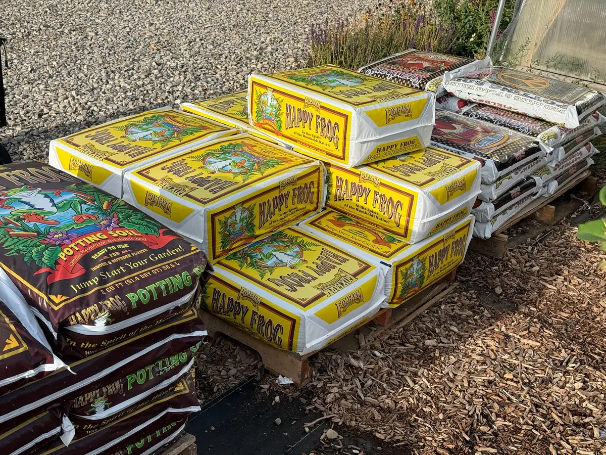 Stacked bags of Happy Frog potting soil on a pallet